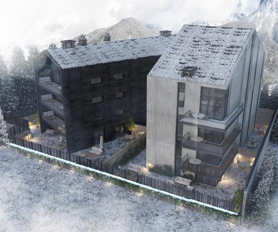 Faraya 2427 — aerial winter view showing two boutique buildings nestled in snowy mountain landscape